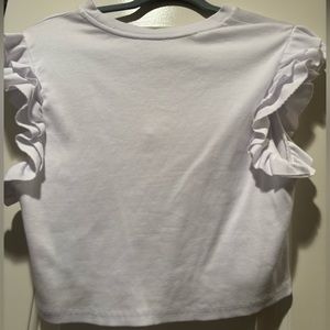 Francesca’s white shirt with ruffled sleeves